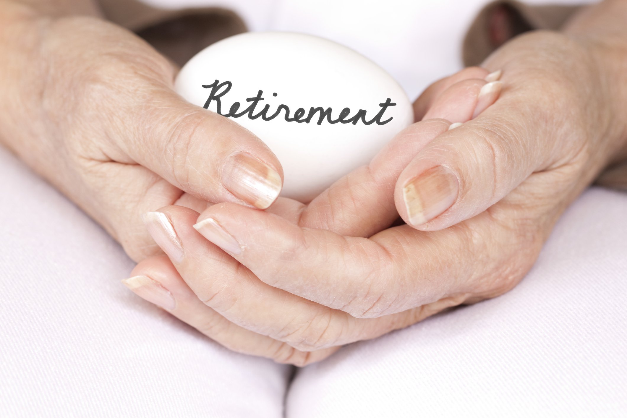 Hands cradling egg with the word Retirement written on it