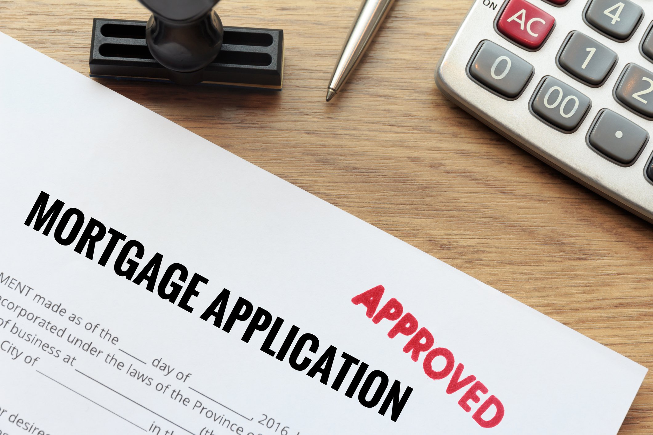 Mortgage application with red Approved stamp