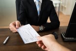 a check exchanges hands