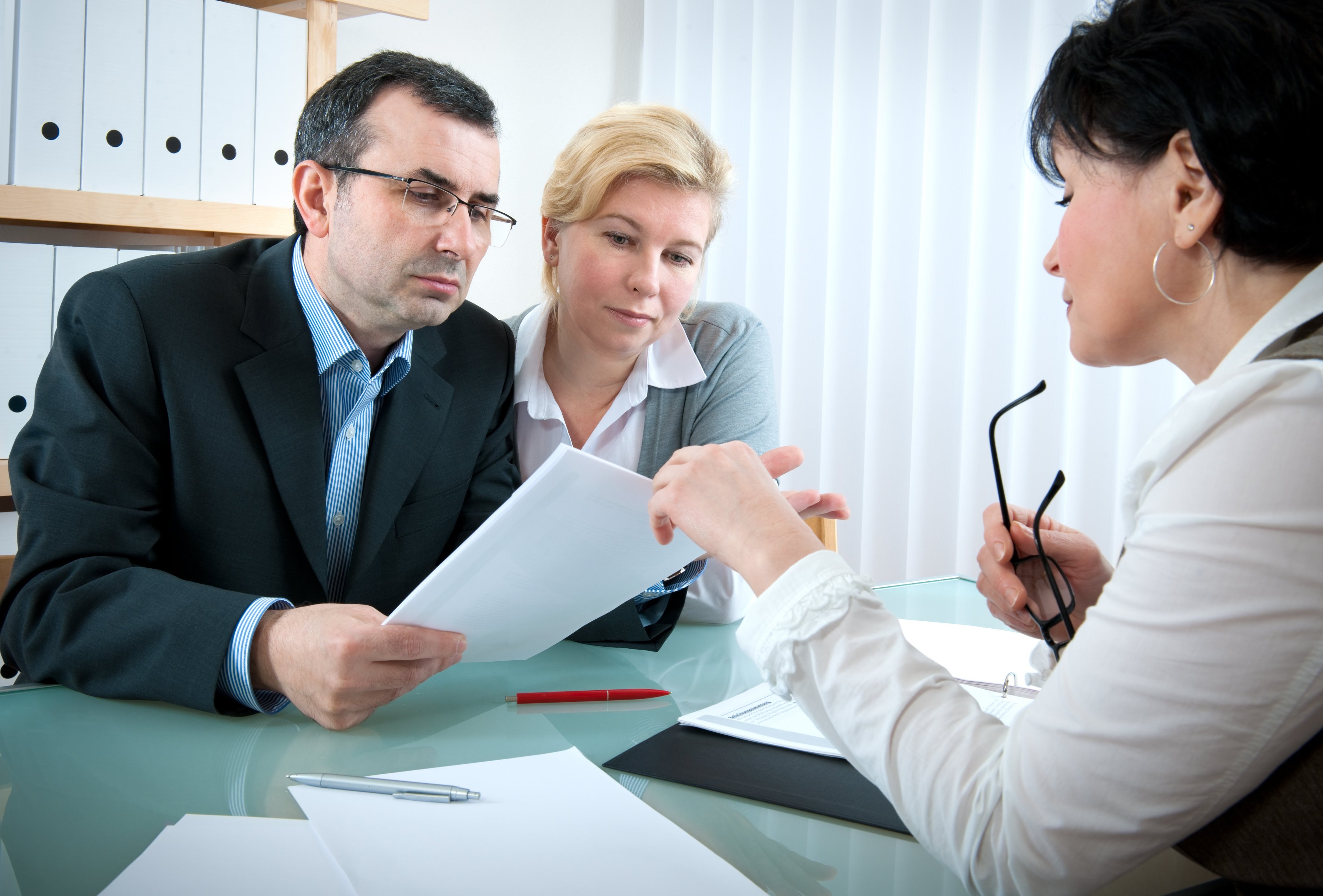 40-something couple meeting with investment advisor