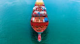 A shipping barge loaded with metal shipping crates.