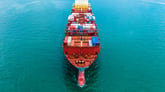 A shipping barge loaded with metal shipping crates.