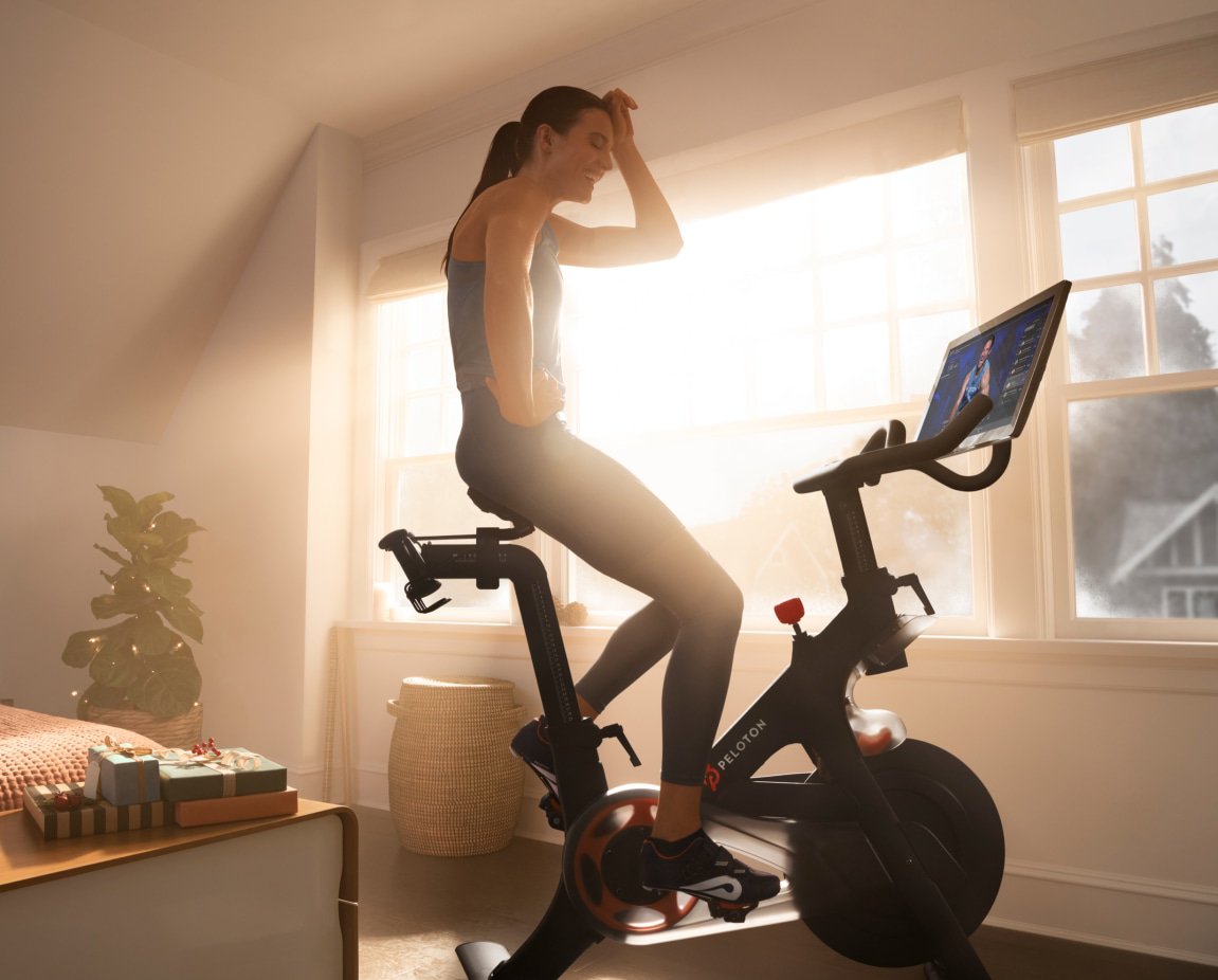 Woman on a Peloton stationary bike.