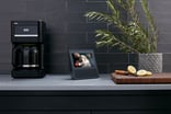 An Alexa device on a kitchen countertop.