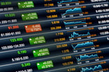 An assortment of various stock index quotes on a digital monitor.