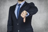 Person in suit giving thumbs down