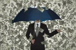 Businessman holding umbrella as money rains down