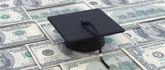 College cost, student loan, scholarship. Graduate cap on dollar banknotes