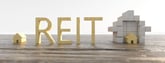 REIT text next to real estate building blocks.jpg