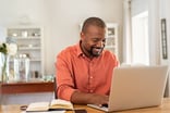 Happy person typing on laptop
