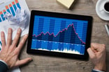 Man looking at declining share price chart on tablet and pounding fist on table stock broker market crash bear correction