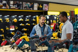 Salesman helping a man buying tools at a hardware store