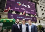 Slack CTO, CFO, and CEO in front of the New York Stock Exchange with a banner announcing the company's IPO.