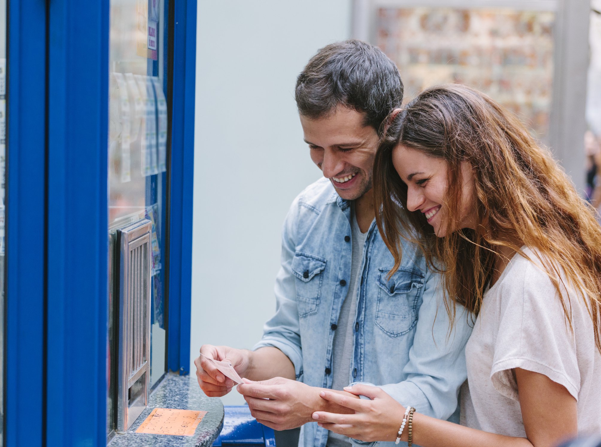 Young couple buying lottery tickets.