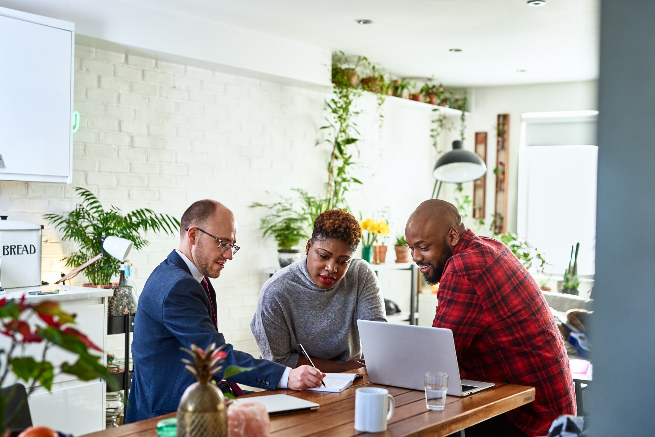 Couple sitting with their financial advisor in a sunny room