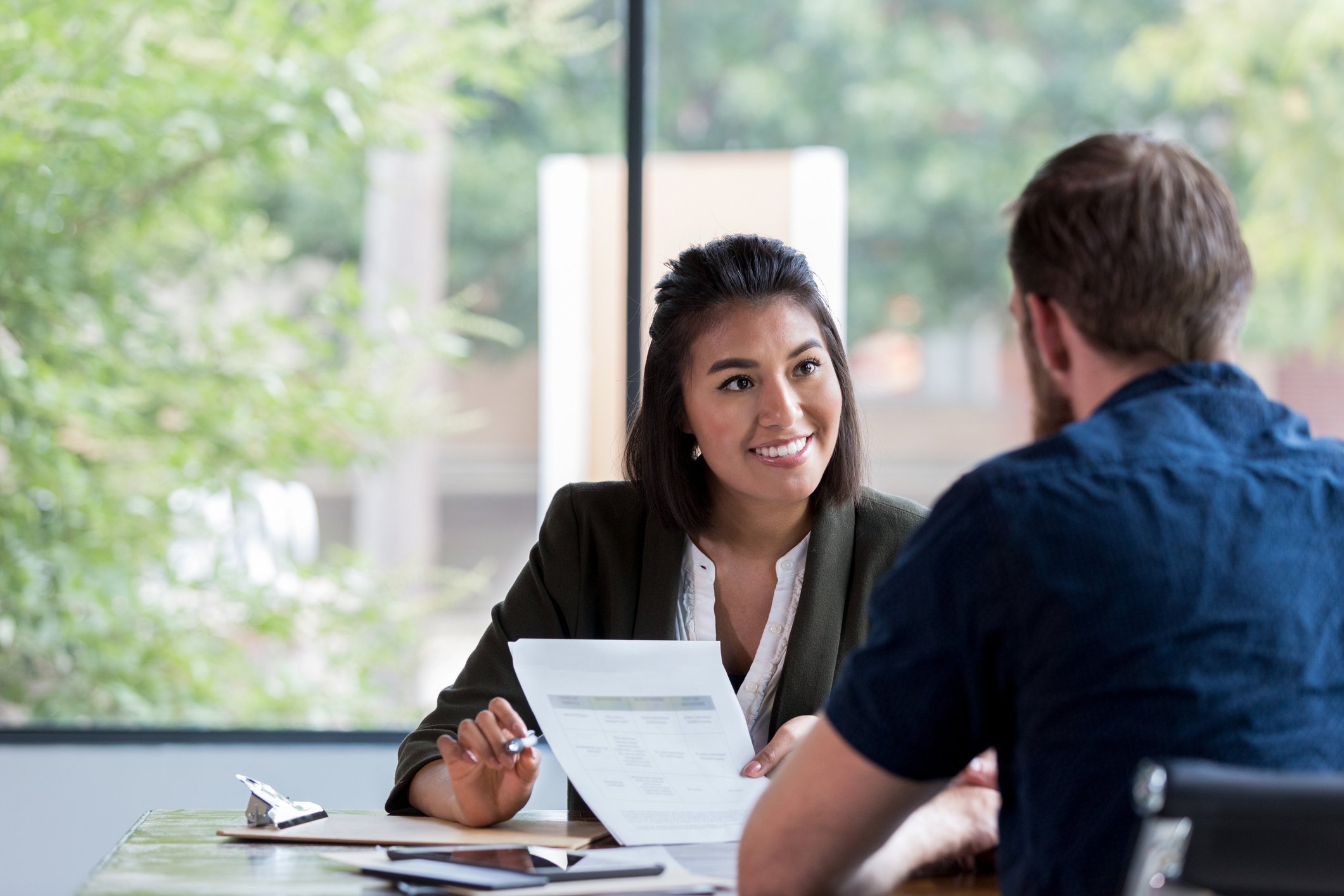 Insurance representative reviewing paperwork with client