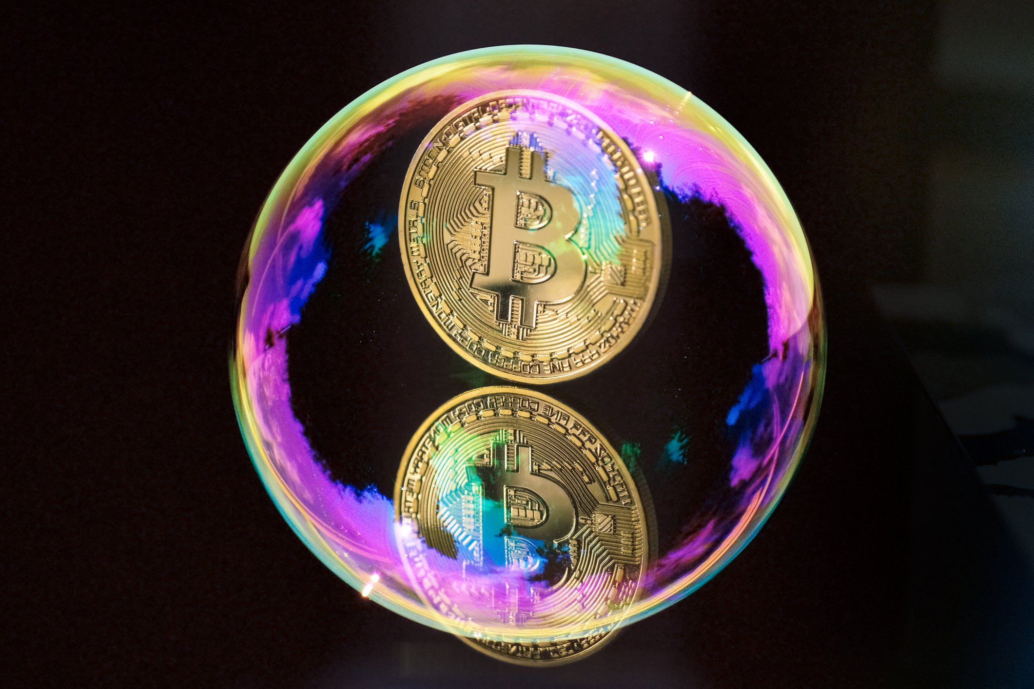 A gold coin with a B on it inside a bubble.