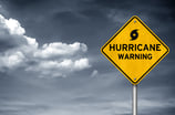 Storm clouds with a Hurricane warning road sign