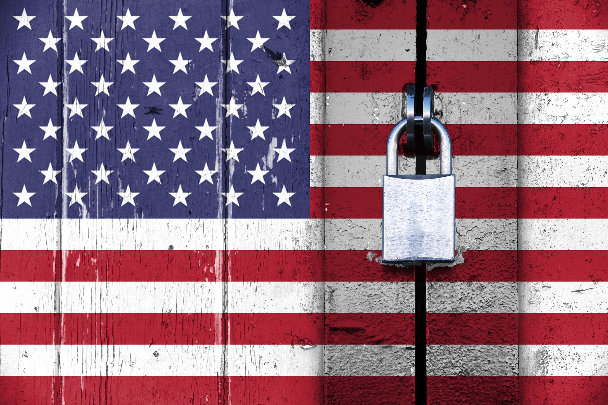 US flag on a wooden door locked with a padlock -- United States American trade embargo isolationism