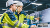 construction worker showing colleague blueprints.jpg