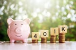 Smiling piggy bank next to rising stacks of coins topped with blocks saying 401k
