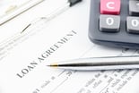 Loan agreement with pen and calculator