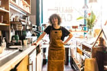 Smiling barista in coffee shop.
