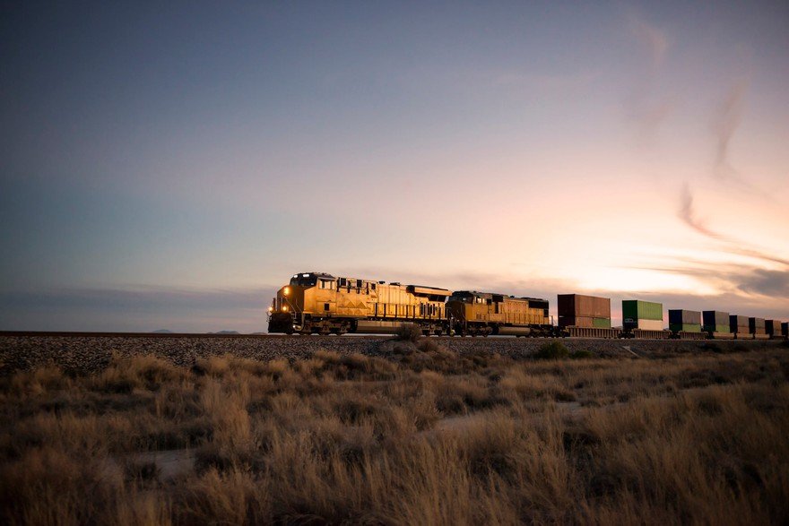 A train rolling through fields.