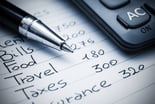 A household budget written out on notebook paper