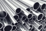 silver metal bars stacked atop one another.jpg