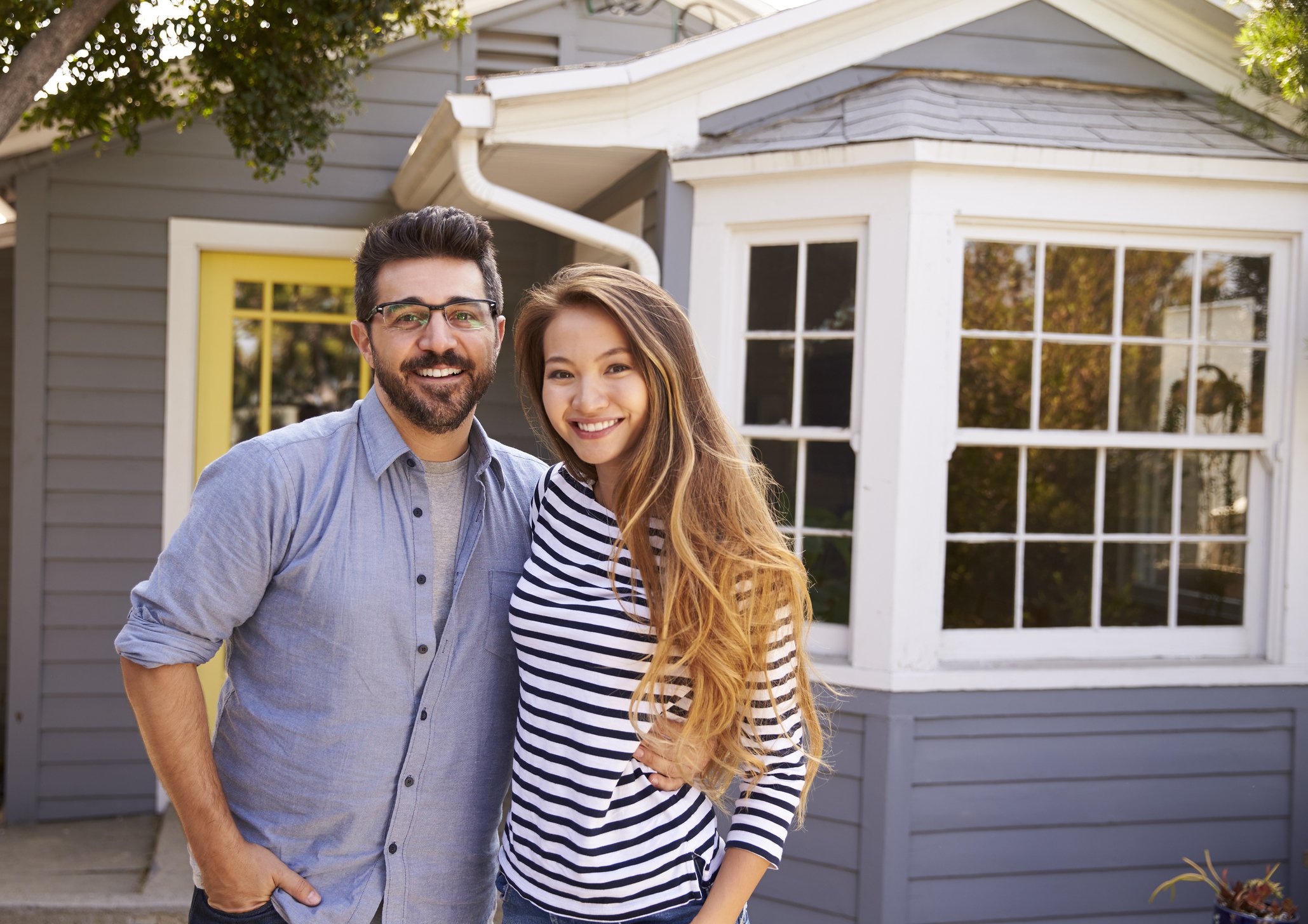couple in front of a house.