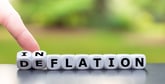 Dice spelling out Deflation being turned over to say Inflation