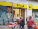 Busy sidewalk outside a Western Union storefront