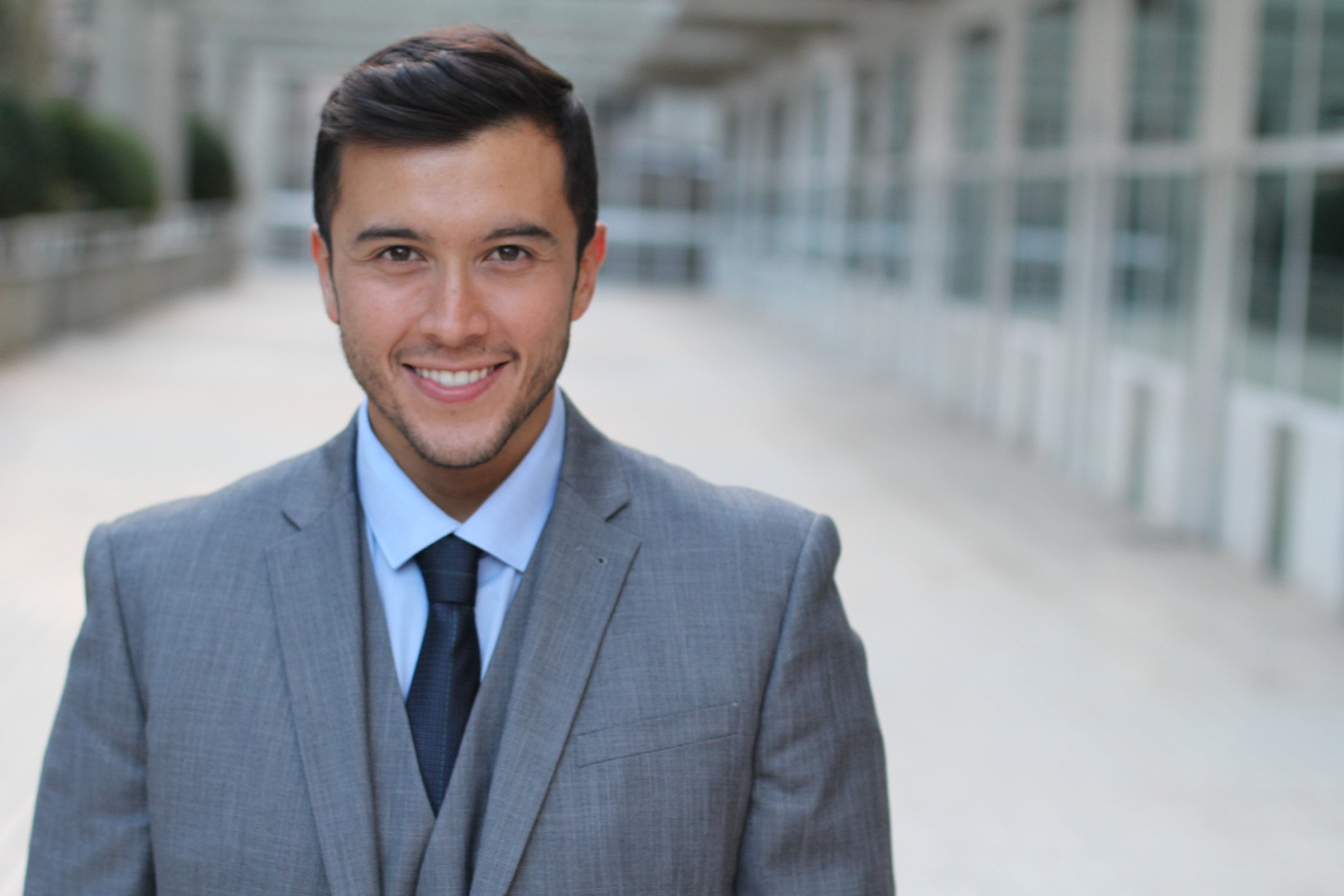 Smiling man in a suit and tie.