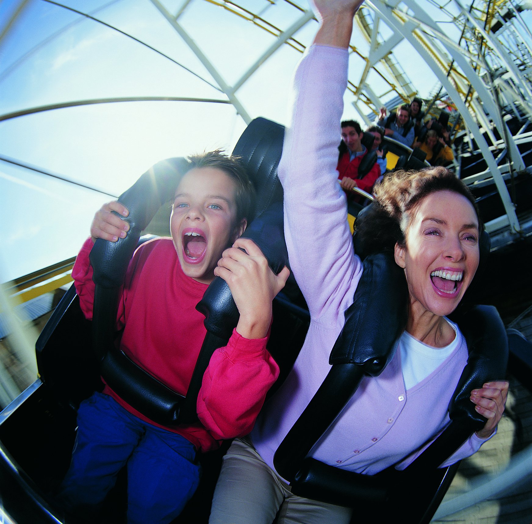 Woman and child enjoy roller coaster.