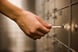 Person using key at safety deposit box.