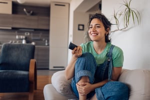 A person watches TV at home.