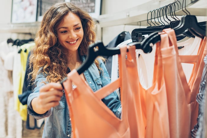 A woman shops for clothes in a store.