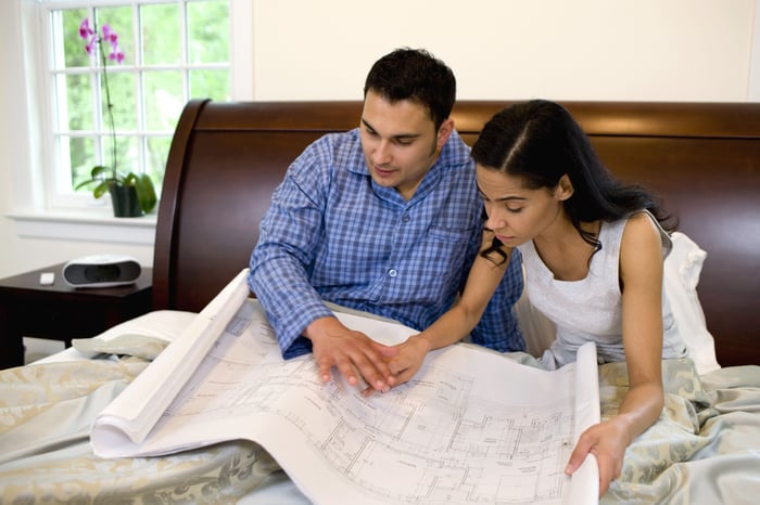 A couple looking at blueprints.