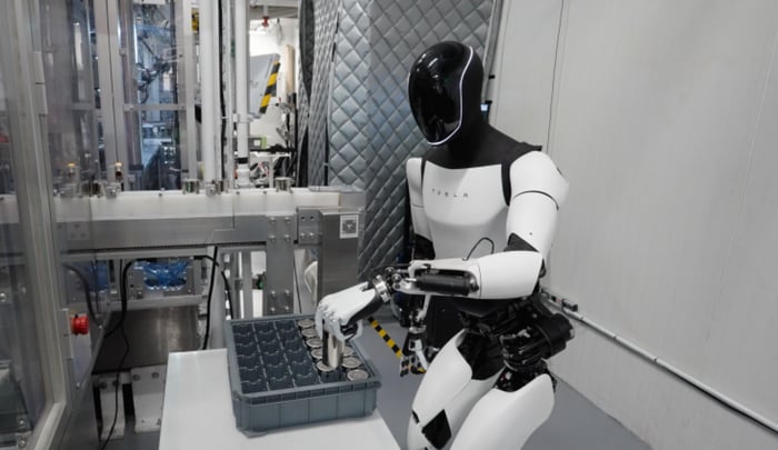 Tesla Optimus humanoid robot working at a simply factory-like job.