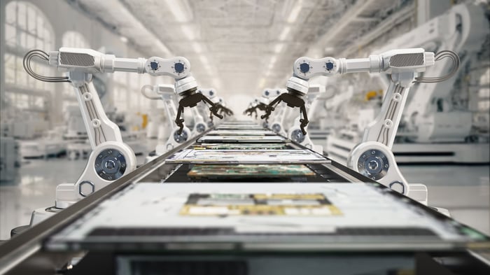 Robotic arms working on an assembly line.
