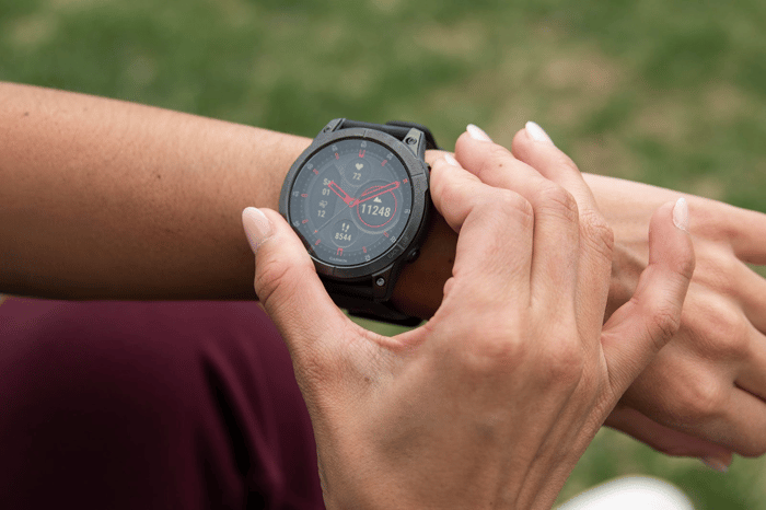 Garmin smart watch on athlete's wrist.